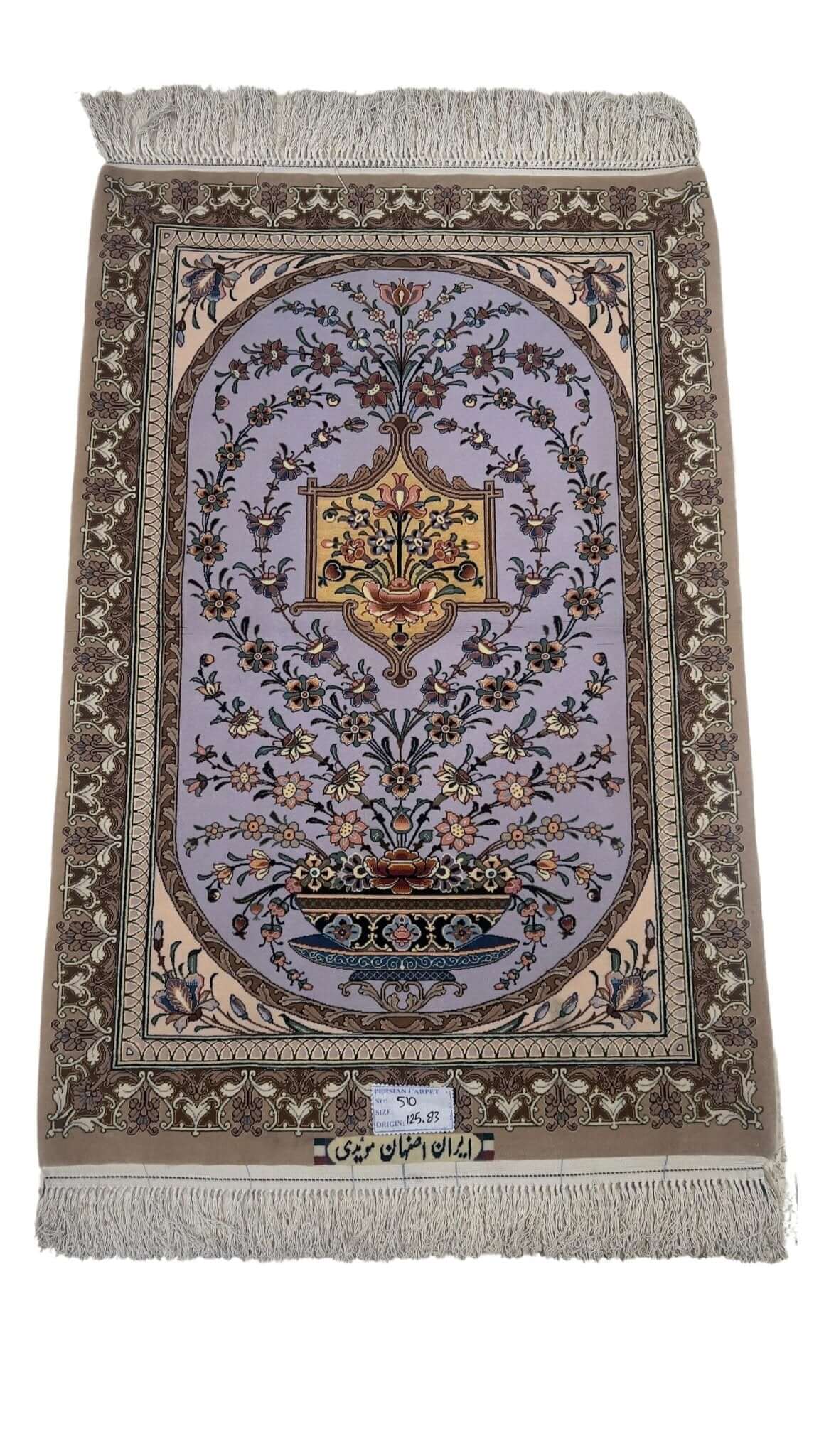 Small brown and purple Persian carpet with floral design
